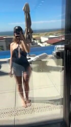 Woman photographs herself poolside in Cabo San Lucas