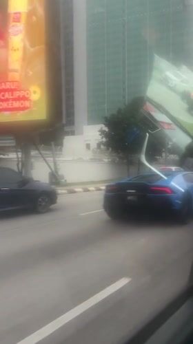 Blue Lamborghini spotted driving through downtown Kuala Lumpur streets