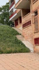 Scooter rider navigates concrete slope near Barcelona building