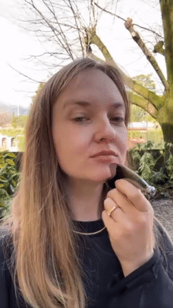 Woman documents facial massage routine with beauty tools in Italy