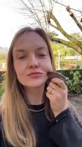 Woman documents facial massage routine with beauty tools in Italy