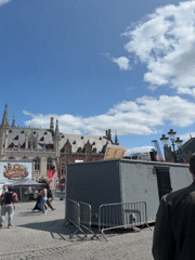 Bruges' Markt square on a clear summer afternoon