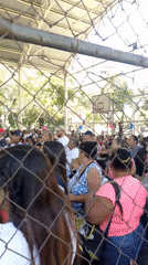 Large crowd gathers under covered structure in Caracas