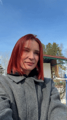 Woman walks dog on sunny winter morning in Chaikovsky