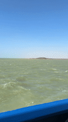 Vessel passes Colombian industrial port under clear skies