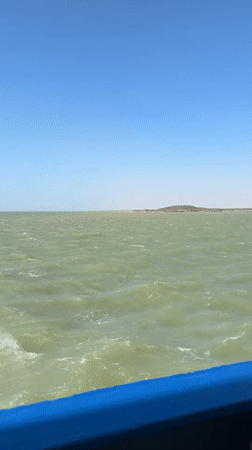 Vessel passes Colombian industrial port under clear skies