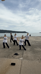 Young dancers perform in matching uniforms on Montenegro pier