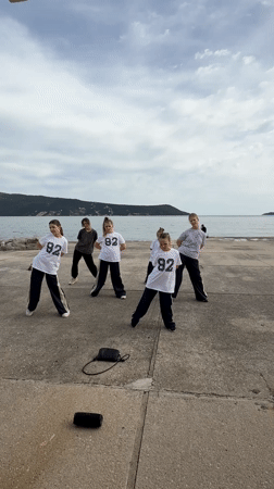 Young dancers perform in matching uniforms on Montenegro pier