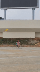 Family flies kites in Da Lat public square