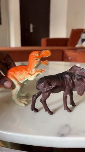 Toy dinosaurs and animals photographed on marble surface in Abuja