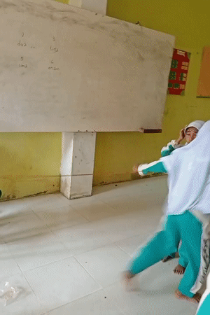 Students in a colorful Indonesian classroom, mid-activity