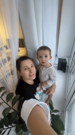 Mother and toddler record home videos in snowy Odintsovo