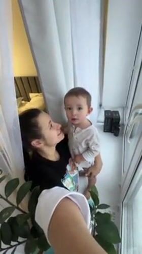 Mother and toddler record home videos in snowy Odintsovo
