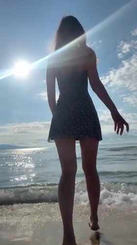 Woman takes beach selfies in sunny Nesebar, Bulgaria morning