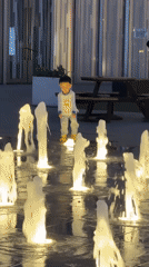 Children play at Beijing fountain amid ordinary district life