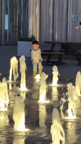 Children play at Beijing fountain amid ordinary district life