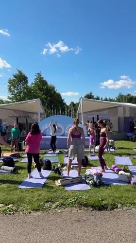 Sunny outdoor festival with stage, tents, and activities in Moscow
