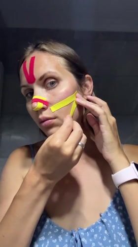 Woman takes bathroom selfies with kinesiology tape in Fethiye