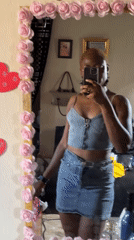 Woman takes mirror selfies in Jalingo, Nigeria indoor setting