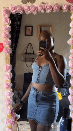 Woman takes mirror selfies in Jalingo, Nigeria indoor setting