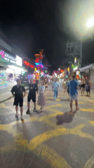 Evening street activity in neon-lit Patong