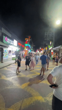 Evening street activity in neon-lit Patong