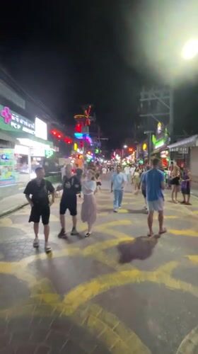 Evening street activity in neon-lit Patong