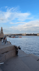 Afternoon stroll captured along Saint Petersburg's Neva River embankment