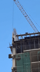 Construction worker spotted atop unfinished building during daytime work