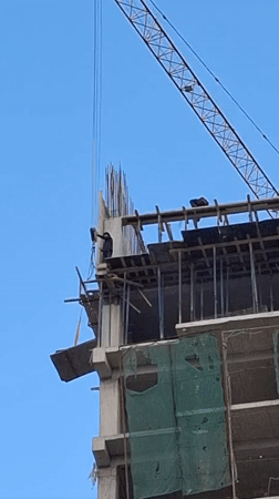 Construction worker spotted atop unfinished building during daytime work
