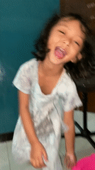 Child fed rice, plays indoors in Gelam, Indonesia