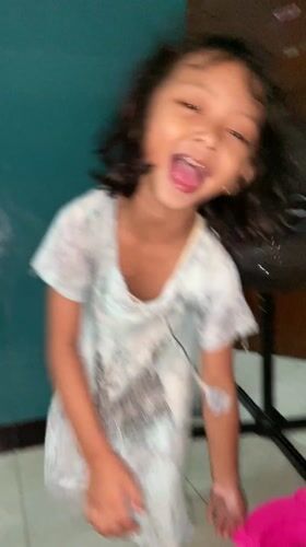 Child fed rice, plays indoors in Gelam, Indonesia