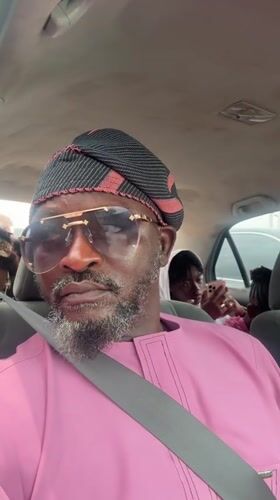 Man in pink shirt and aviator sunglasses recorded in Ado