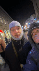 Couple's Winter Night Walk Through Illuminated Belgrade Streets