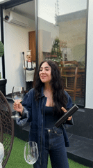 Couple shares white wine on patio in Mexico