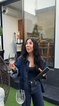 Couple shares white wine on patio in Mexico