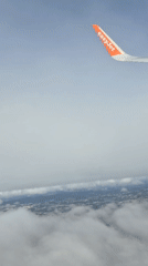 EasyJet passenger captures aerial view over cloudy Porto landscape