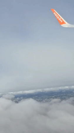 EasyJet passenger captures aerial view over cloudy Porto landscape
