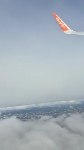 EasyJet passenger captures aerial view over cloudy Porto landscape
