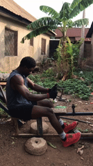 Man exercises on homemade equipment in Akwanga courtyard
