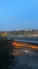Eiffel Tower's colorful evening light display viewed from Saint-Cloud