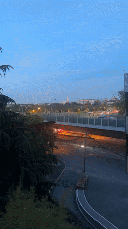 Eiffel Tower's colorful evening light display viewed from Saint-Cloud