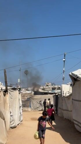 Morning scenes captured across Gaza settlement amid distant smoke