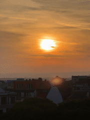 Hazy orange sunset observed over Varna cityscape
