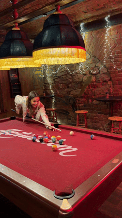 Woman plays pool at Krasnoyarsk bar
