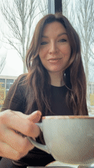 Woman enjoys chocolate and coffee at modern café