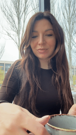 Woman enjoys chocolate and coffee at modern café