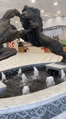 Bronze man-versus-lion statue documented in Yekaterinburg mall fountain