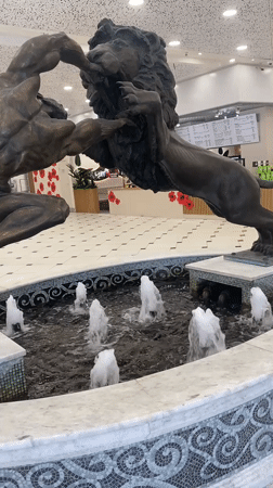 Bronze man-versus-lion statue documented in Yekaterinburg mall fountain