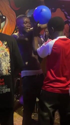 Young adults gather at dimly lit venue in Durimi Nigeria